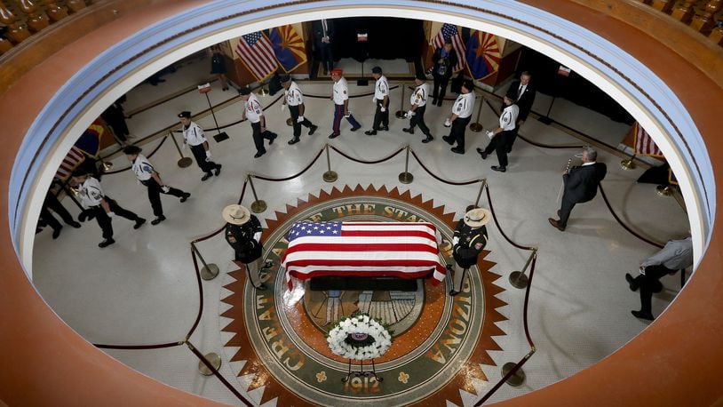 PHOENIX, AZ - AUGUST 29: Veterans walk past the casket of Sen. John McCain, R-Ariz. during a memorial service at the Arizona Capitol on August 29, 2018 in Phoenix, Arizona. Sen. McCain, a decorated war hero, died August 25 at the age of 81 after a long battle with Glioblastoma, a form of brain cancer. (Photo by Ross D. Franklin-Pool via Getty Images) *** BESTPIX ***
