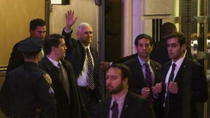Vice President-elect Mike Pence, top center, leaves the Richard Rodgers Theatre after a performance of "Hamilton," in New York on Friday.