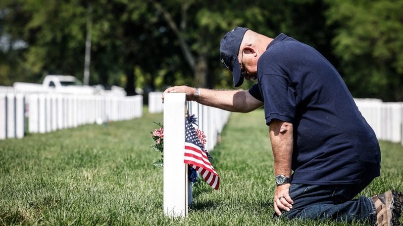 Fairborn resident and retired Air Force Master Sgt. Henry Harlow delivers a flag to friend buried at the Dayton National Cemetery on West Third Street in 2022. JIM NOELKER/STAFF