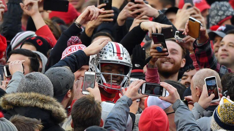 COLUMBUS, OH - NOVEMBER 24:  Quarterback Dwayne Haskins #7 of the Ohio State Buckeyes is congratulated by fans as he walks off the field after defeating the Michigan Wolverines at Ohio Stadium on November 24, 2018 in Columbus, Ohio. Ohio State defeated Michigan 62-39.  (Photo by Jamie Sabau/Getty Images)