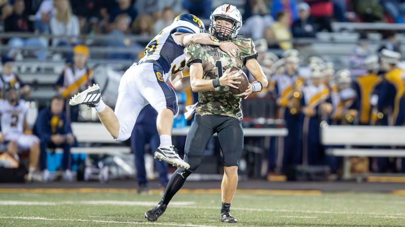 Oakwood High School senior Nate Wertz leaps to tackle Waynesville junior quarterback Alex Amburgey during their game on Thursday night at Spartan Community Stadium. Waynesville won 45-14. CONTRIBUTED PHOTO BY MICHAEL COOPER