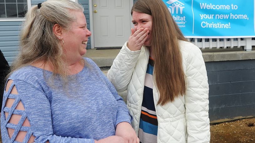 Christine Creager, left and her daughter Kansas, express their emotions after moving back into their home on Macready Ave. that was destroyed by the 2019 Memorial Day tornados. 
Habitat for Humanity and the Miami Valley Long-Term Recovery Operations Group welcome the Creagers home Tuesday, March 16, 2021. MARSHALL GORBY/STAFF