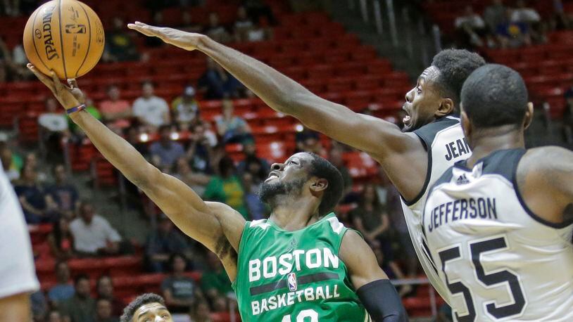 Boston Celtics guard Scoochie Smith (40) lays the ball up as San Antonio Spurs forward Livio Jean-Charles, right rear, and  forward Cory Jefferson (55) defend during the first half of an NBA summer league basketball game Wednesday, July 5, 2017, in Salt Lake City. (AP Photo/Rick Bowmer)