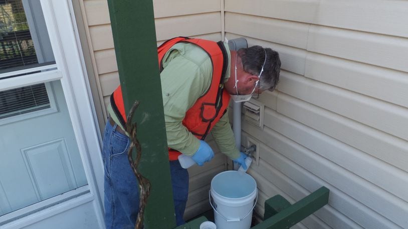 A Wright Patterson Force Base contractor collects drinking water samples in May 2021 from a home in Fairborn. The base sampled 22 wells in nearby neighborhoods for a group of contaminants known as PFAS. Contributed
