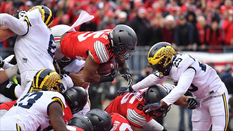 COLUMBUS, OH - NOVEMBER 26:   Mike Weber #25 of the Ohio State Buckeyes dives into the end zone for a touchdown during the second half against the Michigan Wolverines at Ohio Stadium on November 26, 2016 in Columbus, Ohio.  (Photo by Jamie Sabau/Getty Images)