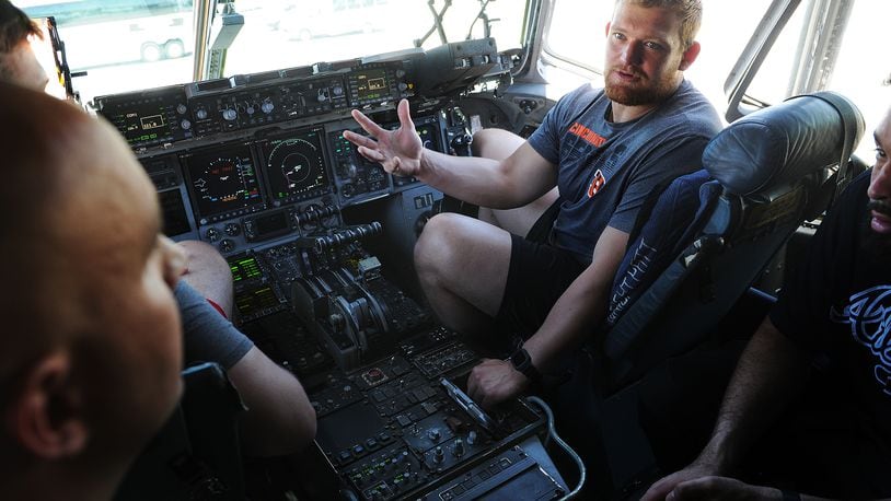Cincinnati Bengals fourth-round draft pick Cordell Volson sits in the pilot seat of a C-17 aircraft at the 445th Airlift Wing at Wright-Patterson Air Force Base Friday on June 3, 2022.  MARSHALL GORBY\STAFF