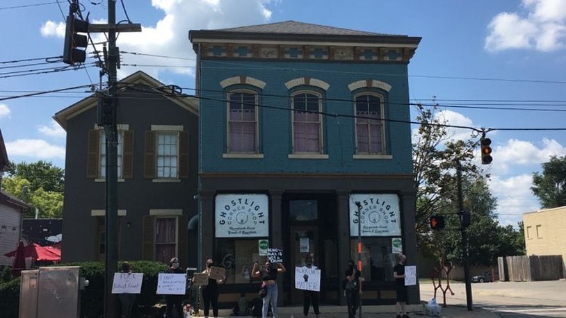 Protesters with Miami Valley Abolitionist and other Dayton residents gather outside the Ghostlight Coffee shop on Saturday, Aug. 22.