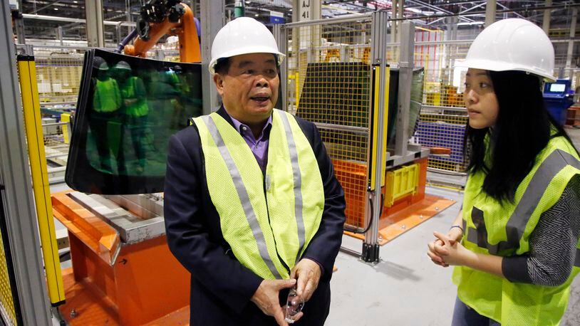 Cho Tak Wong, chairman, Fuyao Glass Industry Group Co. LTD., left, on a visit to Fuyao Glass America in Moraine. TY GREENLEES / STAFF