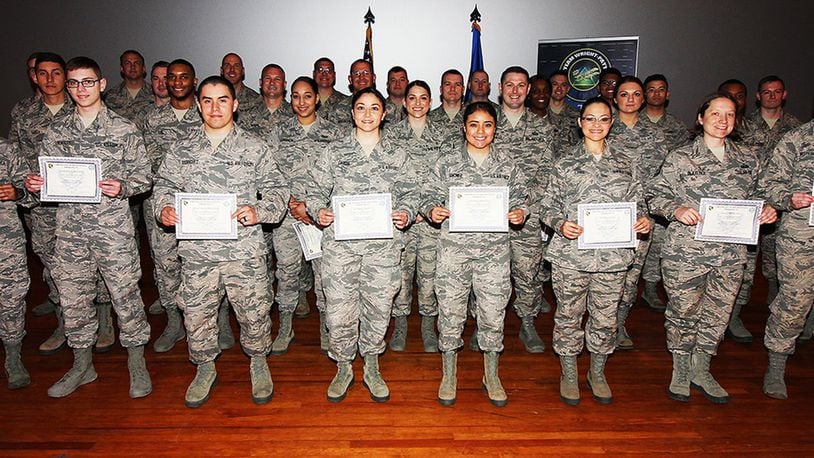 Col. Bradley McDonald, 88th Air Base Wing and installation commander, (left), and Chief Master Sgt. Paula Eischen, 88th Air Base Wing command chief (right), celebrated the newest Team Wratt-Patt enlisted promotees during a ceremony at the base theater, Wright-Patterson Air Force Base, Ohio, April 30, 2018. (U.S. Air Force photo/Thomas Lewis)