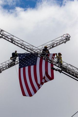 Firefighters put U.S. flag across Third Street