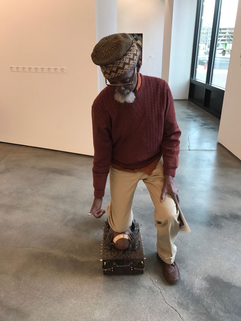 Bing 5 & Bing 6 - the internationally acclaimed Dayton artist Bing Davis - once a high school and college basketball and court star - takes a knee on one of his knees in his exhibition "Kneel" which binds Colin Kaepernick's silent protests and the assassination of George Floyd.  Tom Archdeacon / STAFF