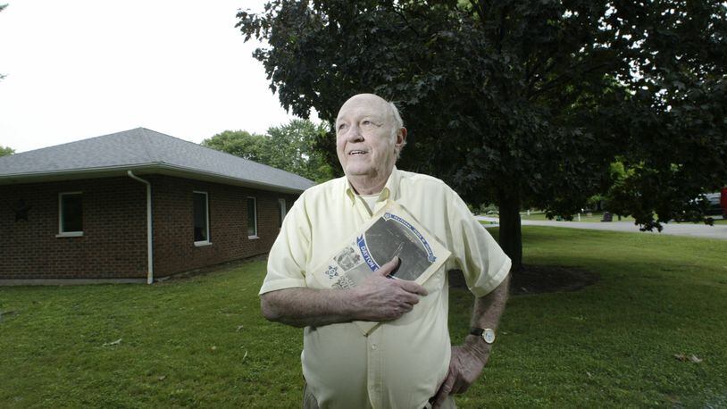 A 2007 photo of retired Dayton Police Officer Tom Sammons. Sammons took advantage of a short-lived loophole in the Dayton city worker residency requirements to move into this Beavercreek neighborhood in the early 1970s. When his daughter was an infant he planted the maple tree at right. Staff photo by Chris Stewart