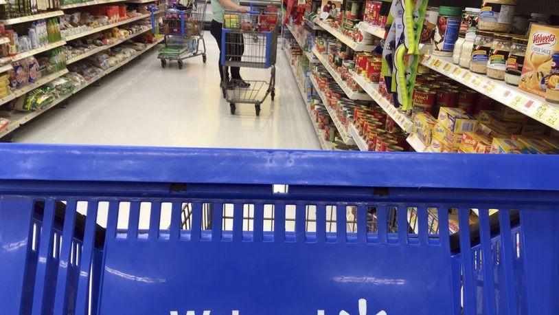 FILE- In this June 5, 2017, file photo, customers shop for food at Walmart in Salem, N.H. Walmart reports financial results Tuesday, Feb. 20, 2018. (AP Photo/Elise Amendola, File)