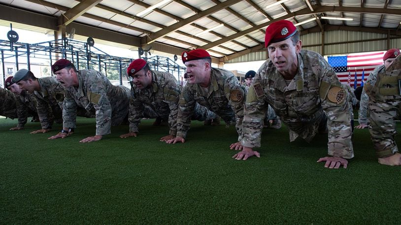 Members of the Special Warfare Training Wing honor the fallen with memorial push-ups after the SWTW activation ceremony at Joint Base San Antonio-Medina Base, Texas, Oct. 10. The mission of the new wing is to select, train, equip and mentor Airmen to conduct global combat operations in contested, denied, operationally limited, and permissive environments under any environmental conditions. (U.S. Air Force photo/Andrew C. Patterson)