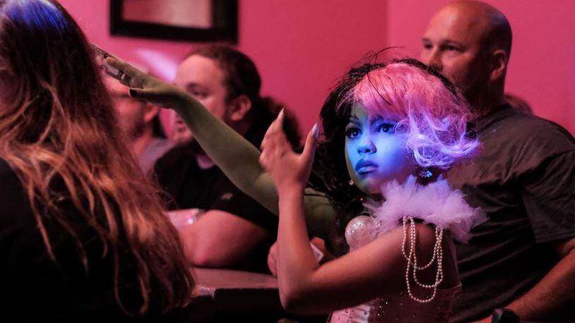 Jacob Measley, 9, dressed as drag queen ‘Miss Mae Hem’ watches other drag performers Aug. 11, 2018 at Legends Showclub in Toledo. The Blade