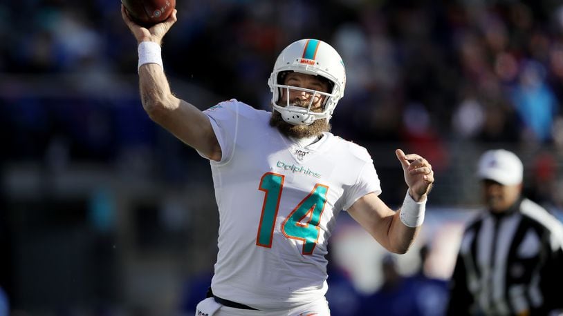 EAST RUTHERFORD, NEW JERSEY - DECEMBER 15: Ryan Fitzpatrick #14 of the Miami Dolphins passes the ball in the first quarter against the New York Giants at MetLife Stadium on December 15, 2019 in East Rutherford, New Jersey. (Photo by Elsa/Getty Images)
