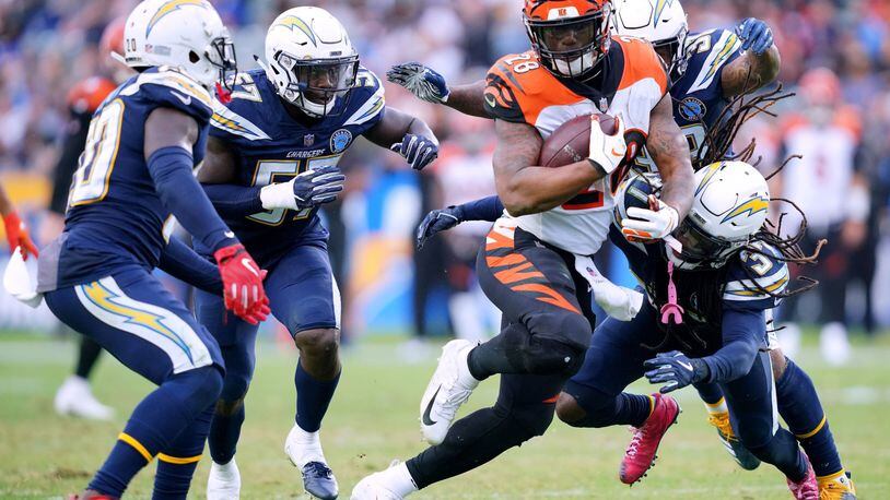 CARSON, CA - DECEMBER 09: Joe Mixon #28 of the Cincinnati Bengals is chased down by Jahleel Addae #37, Desmond King #20 and Jatavis Brown #57 of the Los Angeles Chargers during the fourth quarter in a 26-21 Chargers win at StubHub Center on December 9, 2018 in Carson, California. (Photo by Harry How/Getty Images)