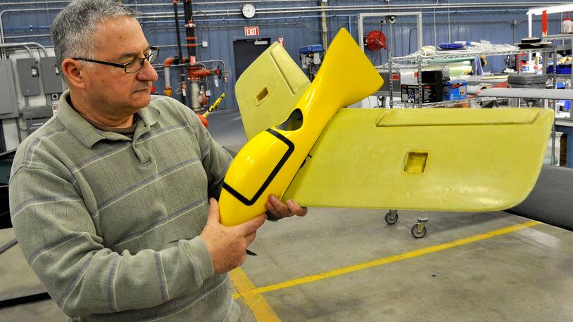 Frank Beafore, executive director of SelectTech GeoSpatial, looks over one of the small UAV's built at the company's Springfield facility.