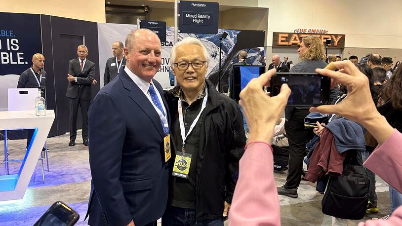 Berkshire Hathaway Vice Chairman Greg Abel poses for pictures with shareholders while touring the booths Berkshires companies set up, Friday, May 3, 2024, in Omaha, Neb. Abel will succeed Warren Buffett as CEO one day. (AP Photo/Josh Funk)