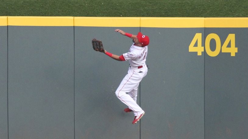 Reds center fielder Billy Hamilton makes a leaping catch against the Padres in August at Great American Ball Park. Such plays give Hamilton a good case for his first Gold Glove. DAVID JABLONSKI / STAFF
