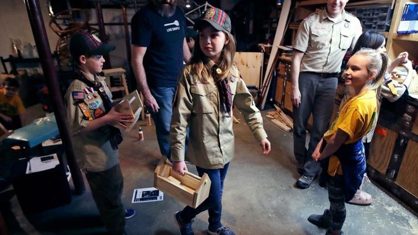 The Boy Scouts of America (BSA) announced that it will be undergoing a significant name change regarding its 108-year program. In this March 1, 2018, file photo, Tatum Weir, center, carries a tool box she built as her twin brother Ian, left, follows after a Cub Scout meeting in Madbury, N.H. Fifteen communities in New Hampshire are part of an “early adopter” program to allow girls to become Cub Scouts and eventually Boy Scouts. For 108 years, the Boy Scouts of America’s flagship program for older boys has been known simply as the Boy Scouts. With girls soon entering the ranks, the BSA says that iconic name will change to Scouts BSA. The change will take effect in February 2019. (AP Photo/Charles Krupa, File)
