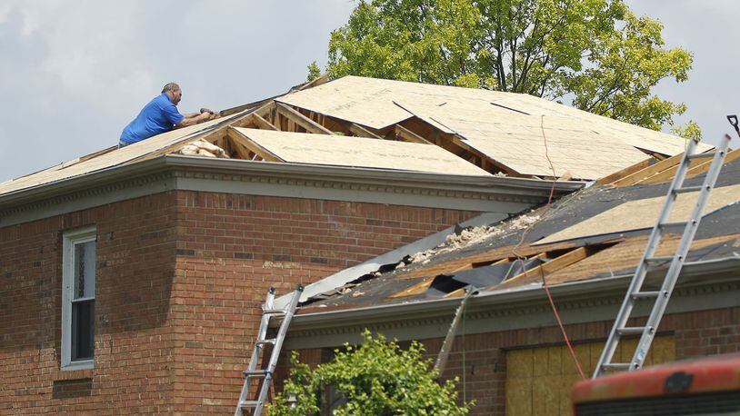 Some damaged Homes on Coppersmith Avenue in Butler Township are having roofs rebuilt. Repairs are underway or waiting for insurance settlements in communities throughout the Dayton area more than one month after the Memorial Day tornadoes tore through many neighborhoods. TY GREENLEES / STAFF