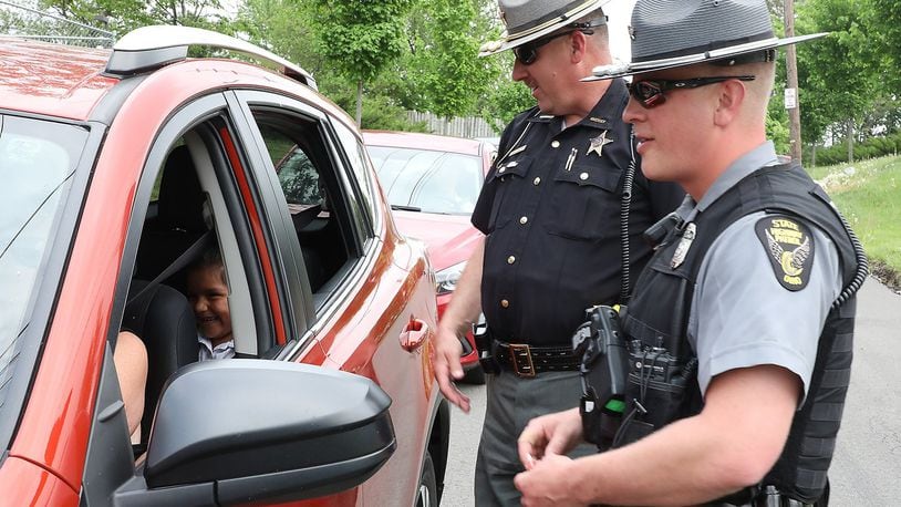 FILE: Clark County Sheriff’s Deputy Mark Lane and Sgt. Merrill Thompson of the Ohio State Highway Patrol check drivers to make sure they are wearing their seatbelts as they leaving Catholic Central High School. The safety check kicked off their Click It Or Ticket campaign that runs through June 4. Bill Lackey/Staff