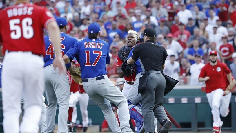 Yasiel Puig of the Cincinnati Reds is restrained after being hit by a pitch from Pedro Strop of the Chicago Cubs in the eighth inning at Great American Ball Park in Cincinnati on Saturday, June 29, 2019. The Cubs won, 6-0. (Joe Robbins/Getty Images)