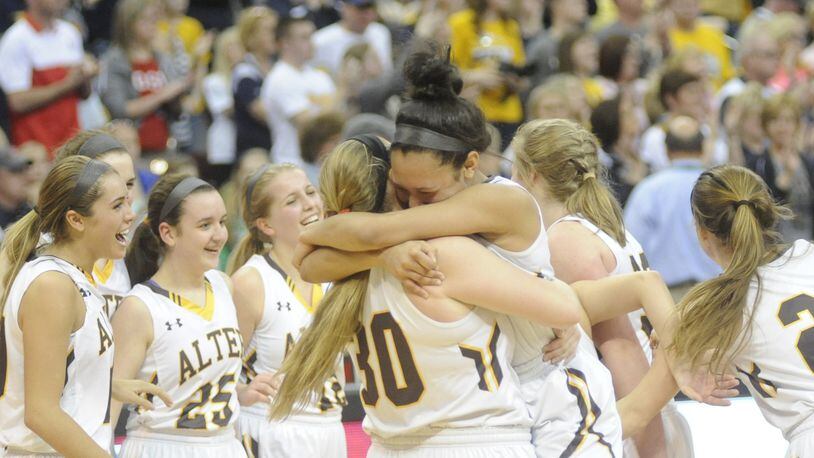 Alter’s Braxtin Miller celebrates with teammate Hayley Combs (30). Alter defeated Ottawa-Glandorf 74-48 to win its second straight girls high school basketball D-II state championship on Saturday, March 12, 2016. MARC PENDLETON / STAFF