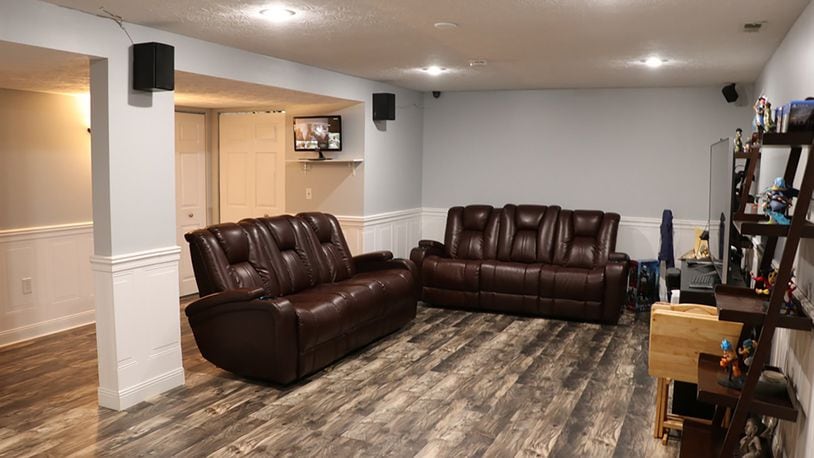 The basement has been finished into a recreation room. There are 2 bonus rooms with closets, and the wood-laminate flooring fills all 3 rooms, including the third full bathroom. The bath has a shower and single-sink vanity.
