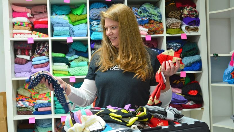 Tammie Rafferty, founder and executive director of Project Believe, sorts some of the more than 700 pair of socks donated by students at Vandalia’s Morton Middle School. CONTRIBUTED