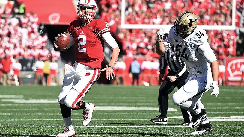 MADISON, WI - OCTOBER 17: Joel Stave #2 of the Wisconsin Badgers is pursued by Jake Replogle #54 of the Purdue Boilermakers during the first quarter of a game against the Purdue Boilermakers at Camp Randall Stadium on October 17, 2015 in Madison, Wisconsin. (Photo by Stacy Revere/Getty Images)