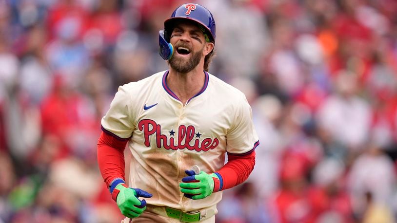 Philadelphia Phillies' Bryce Harper reacts after hitting an RBI-sacrifice flay against Chicago White Sox pitcher Tanner Banks during the fourth inning of a baseball game, Sunday, April 21, 2024, in Philadelphia. (AP Photo/Matt Slocum)