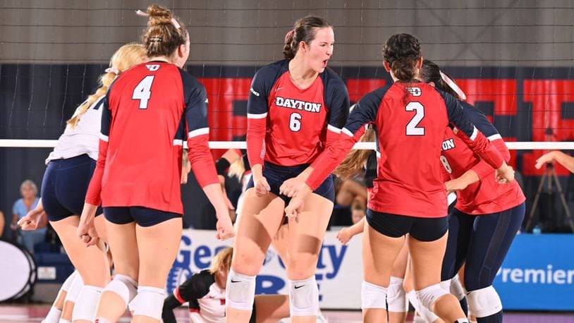 Amelia Moore, center, of the Dayton volleyball team, reacts to a point during a match against Western Kentucky at the Frericks Center on Friday, Aug. 24, 2023. Photo courtesy of University of Dayton Athletics