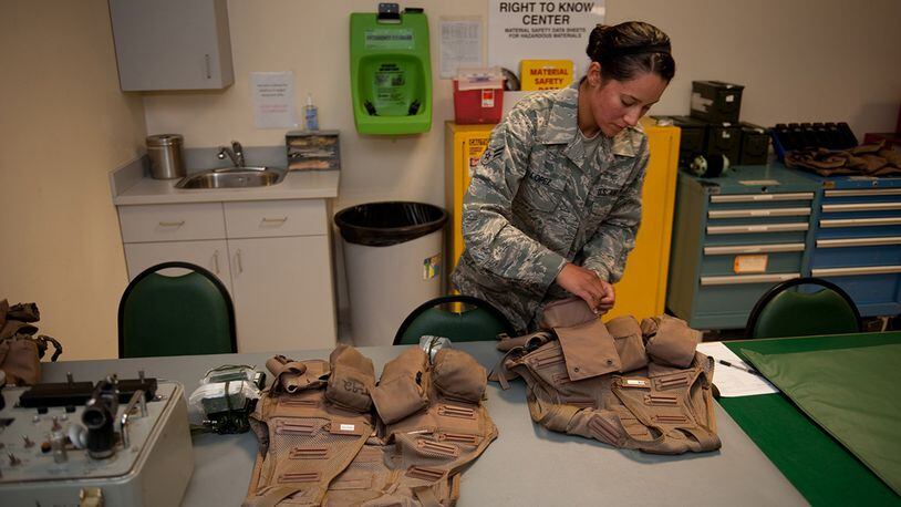 Airman 1st Class Jennifer Lopez, 379th Expeditionary Operations Support Squadron aircrew flight equipment journeyman, prepares and checks survival vests prior to being issued to a B-1B Lancer aircrew in southwest Asia. (U.S. Air Force photo/Staff Sgt. Sharon Singer)