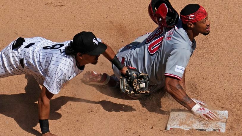 Cincinnati Reds' Will Benson, right, steals second base as Chicago White Sox second baseman Nicky Lopez applies a late tag during the sixth inning of a baseball game in Chicago, Sunday, April 14, 2024. (AP Photo/Nam Y. Huh)