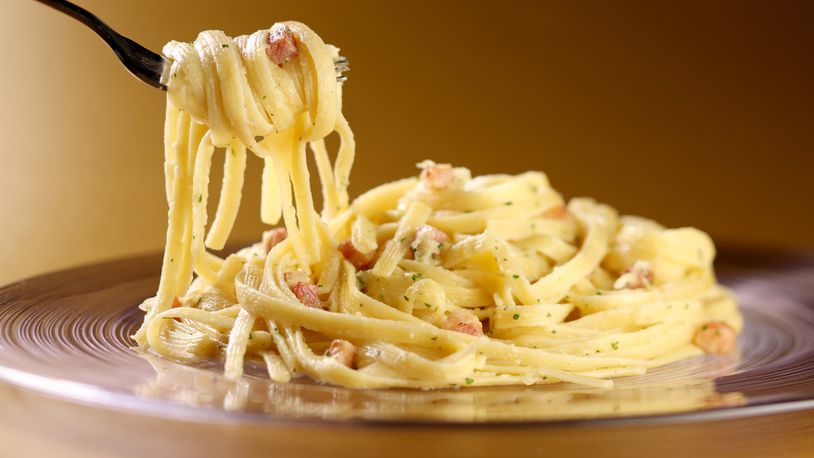 Modern pasta carbonara, with the egg cooked sous vide for an hour, still has the other elements of the classic dish: cheese and pancetta. (Food styling by Mark Graham.) (Michael Tercha/Chicago Tribune/TNS)