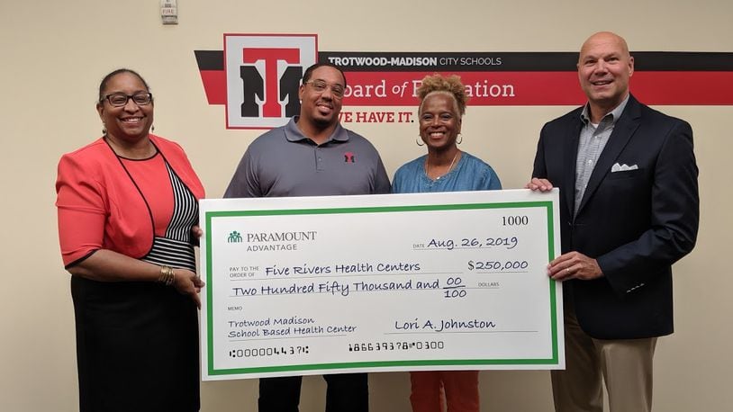 Dayton-based Five Rivers Health Centers, said today that it was awarded a $500,000 grant from Paramount Advantage, a Mediciad insurance plan privately managed by Toledo-based ProMedica. From left, Gina McFarlane-El, CEO, Five Rivers Health Centers; Marlon Howard, Acting Superintendent, Trotwood Madison Schools; Janice Allen, Treasurer, Trotwood Madison Schools; and Tim Petee, Director-Regional Operations, Paramount Healthcare.