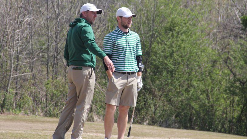 Wright State golf coach Brian Arlinghaus talks to No. 1 player Chris Rossi during the Big Blue Intercollegiate earlier this spring. CONTRIBUTED