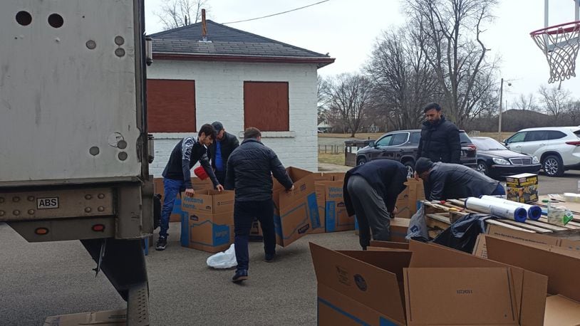 Members of the Osman Gazi Mosque and Dayton's Turkish community package donations, including clothing items, boots, and blankets, on Tuesday to be sent to Turkey for victims of Monday's 7.8 earthquake. SAMANTHA WILDOW\STAFF