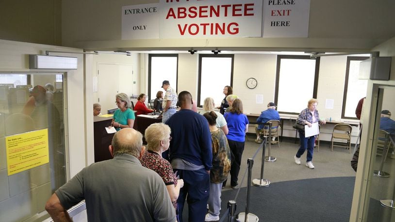 People wait in line to cast their early vote Wednesday at the Clark County Board of Elections. Bill Lackey/Staff