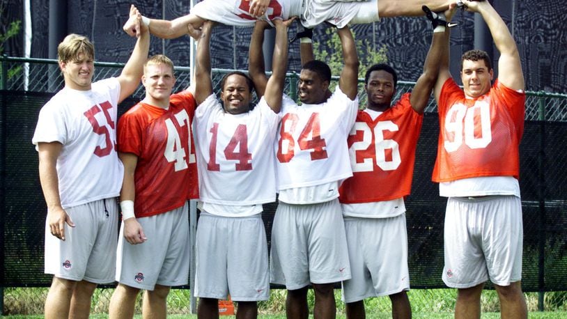 Seven scholarship players from the Miami Valley are currently playing on the OSU Buckeye football team (2002). They are L-R: Nick Mangold (Alter), A.J. Hawk (Centerville), Angelo Chattams (CJ), John Hollins (Wayne), Will Allen (Wayne) and Quinn Pitcock (Piqua) all hold kicker Mike Nugent (Centerville) above their heads.