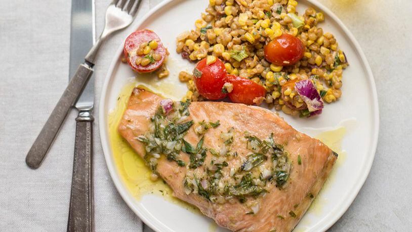 This November 2017 photo shows salmon with a tarragon vinaigrette in New York. this dish is from a recipe by Katie Workman. (Mia via AP)