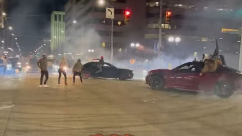 Cars do donuts and drive in circles at East Third Street and Jefferson Street in downtown Dayton over the weekend. YOUTUBE
