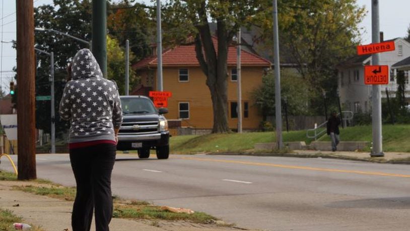 A woman walks along North Main Street, headed toward Helena Street, which is where a woman was shot Wednesday morning. North Main Street is a hotbed of prostitution and other criminal activities, according to neighbors and police. CORNELIUS FROLIK / STAFF