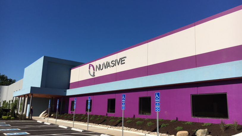 NuVasive cut the ribbon last July on what it called the “largest and most advanced spine medical device factory in the world” in West Carrollton. THOMAS GNAU/STAFF