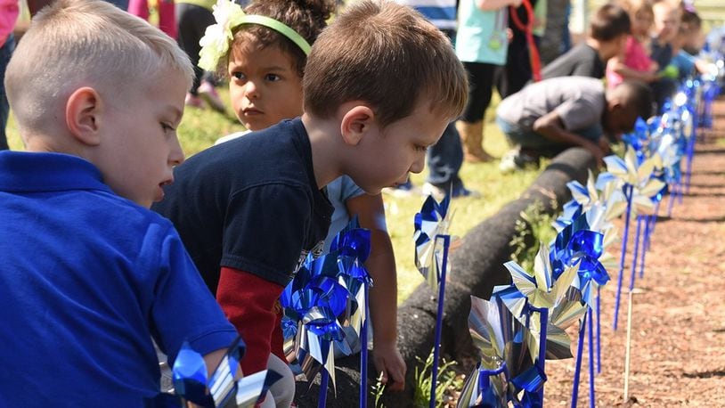 Military Child Development Centers plant pinwheels around the base to raise awareness on child abuse. The Wright-Patterson Family Advocacy Program is hosting a number of events in April to observe Child Abuse Prevention Month. (U.S. Air Force photo/Airman 1st Class Victoria Boyton)