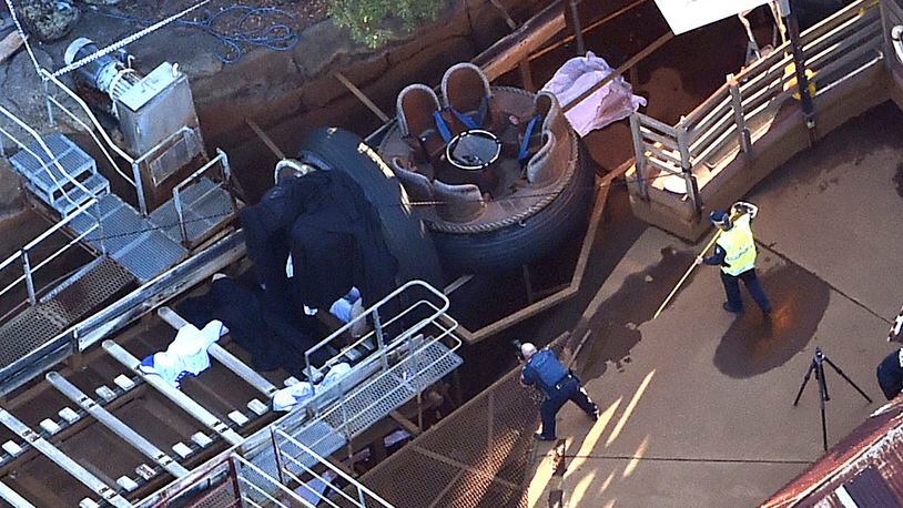 Queensland Emergency Services personnel are seen at the Thunder River Rapids ride at Dreamworld on the Gold Coast, Australia, Tuesday, Oct. 25, 2016. Four people died after a malfunction caused two people to be ejected from their raft, while two others were caught inside the ride at the popular theme park. (Dan Peled/AAP via AP)