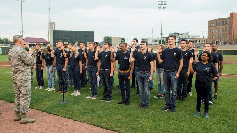 Lt. Gen. Robert McMurry, Air Force Life Cycle Management Center commander, administers the oath of enlistment to 31 members of the delayed enlistment program during the Hometown Heroes military appreciation night at Fifth Third Field Aug 18. (U.S. Air Force photo/Wesley Farnsworth)