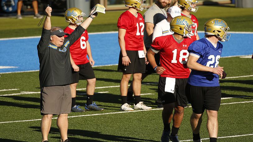 UCLA head coach Chip Kelly, left, works with his players on the Spaulding practice field in Los Angeles on March 6, 2018. (Al Seib/Los Angeles Times/TNS)